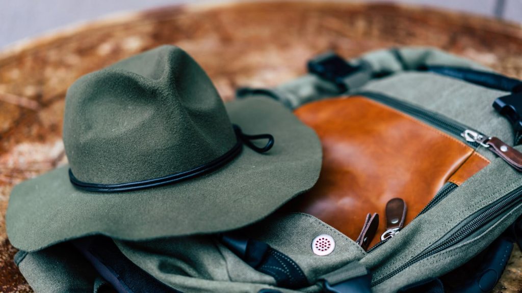 A hat placed atop a backpack, ready for outdoor adventures or travel.